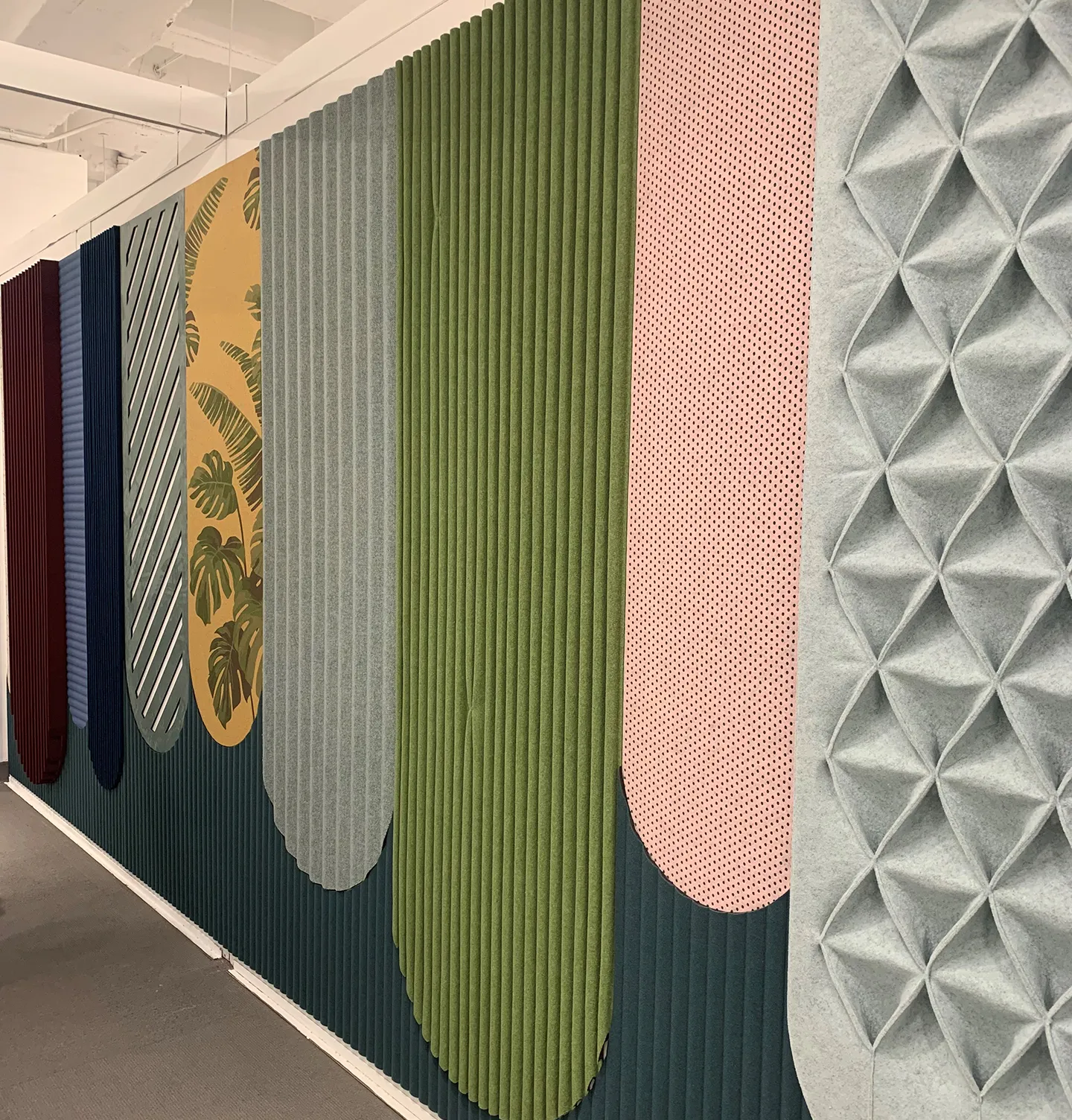 Unique design of acoustic panels through colorful arches and different textures.