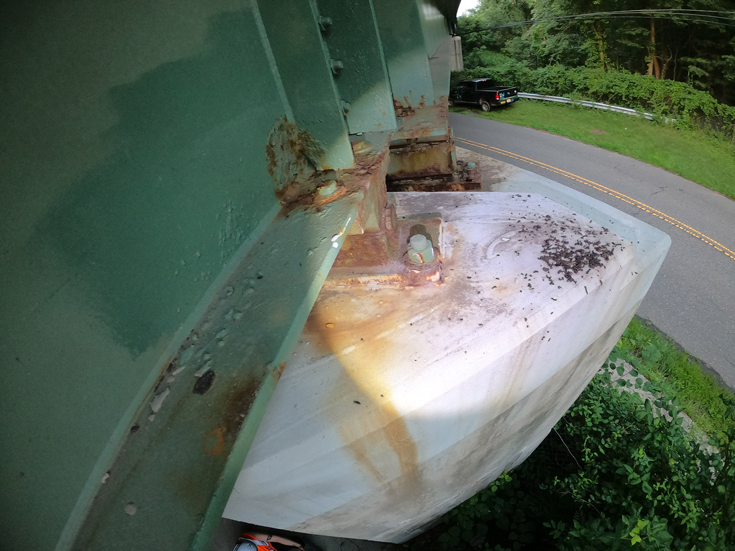 A bridge pier cap that has a collection of guano from bats using the bridge crack. 