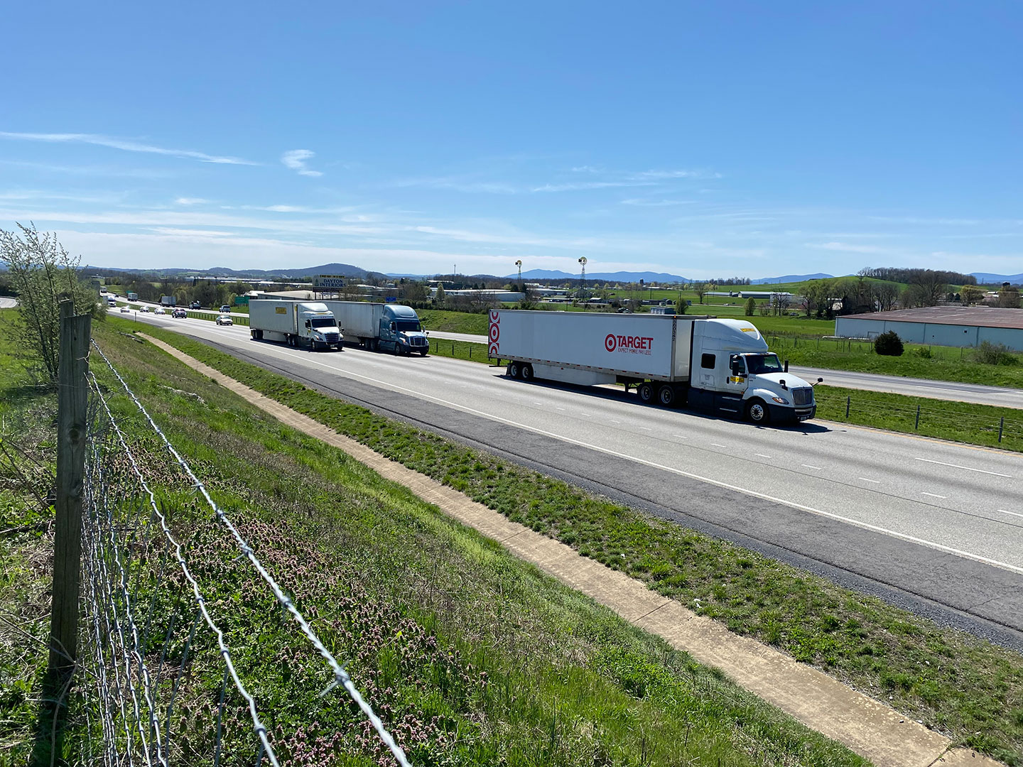 Semi-trucks on a highway interstate.