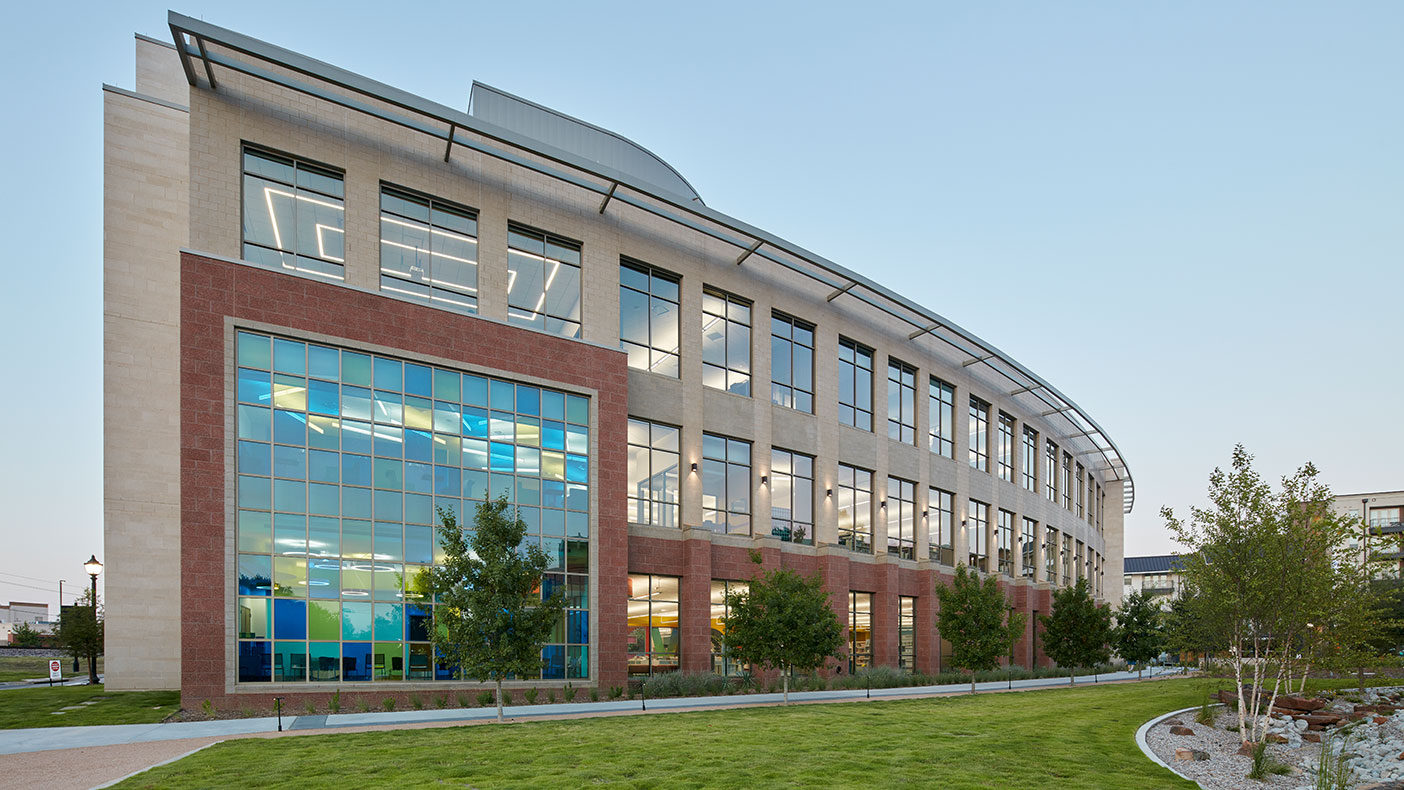 The iconic multi-colored glass feature and abundant windows offer a peek into the many offerings the library has in store.