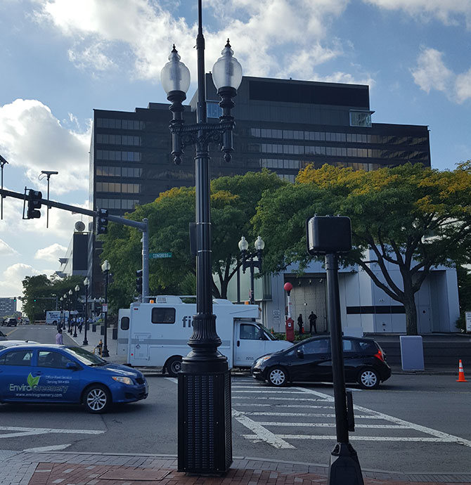 A decorative steel “smart pole” with integrated radio equipment in the base lights to match the city standard, and an omni antenna is mounted to the center mast.