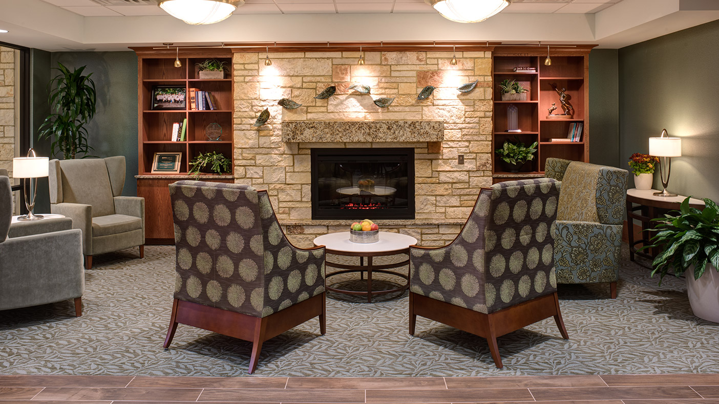 The design draws patients and caregivers into one of many intimate spaces promoting relaxation, which include fireplaces, a grand piano, and a large aquarium. 