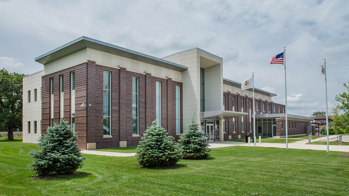 A landscaped plaza, flag court, and two-story entry welcome the public into the 35,600-square-foot DeKalb Police Headquarters.