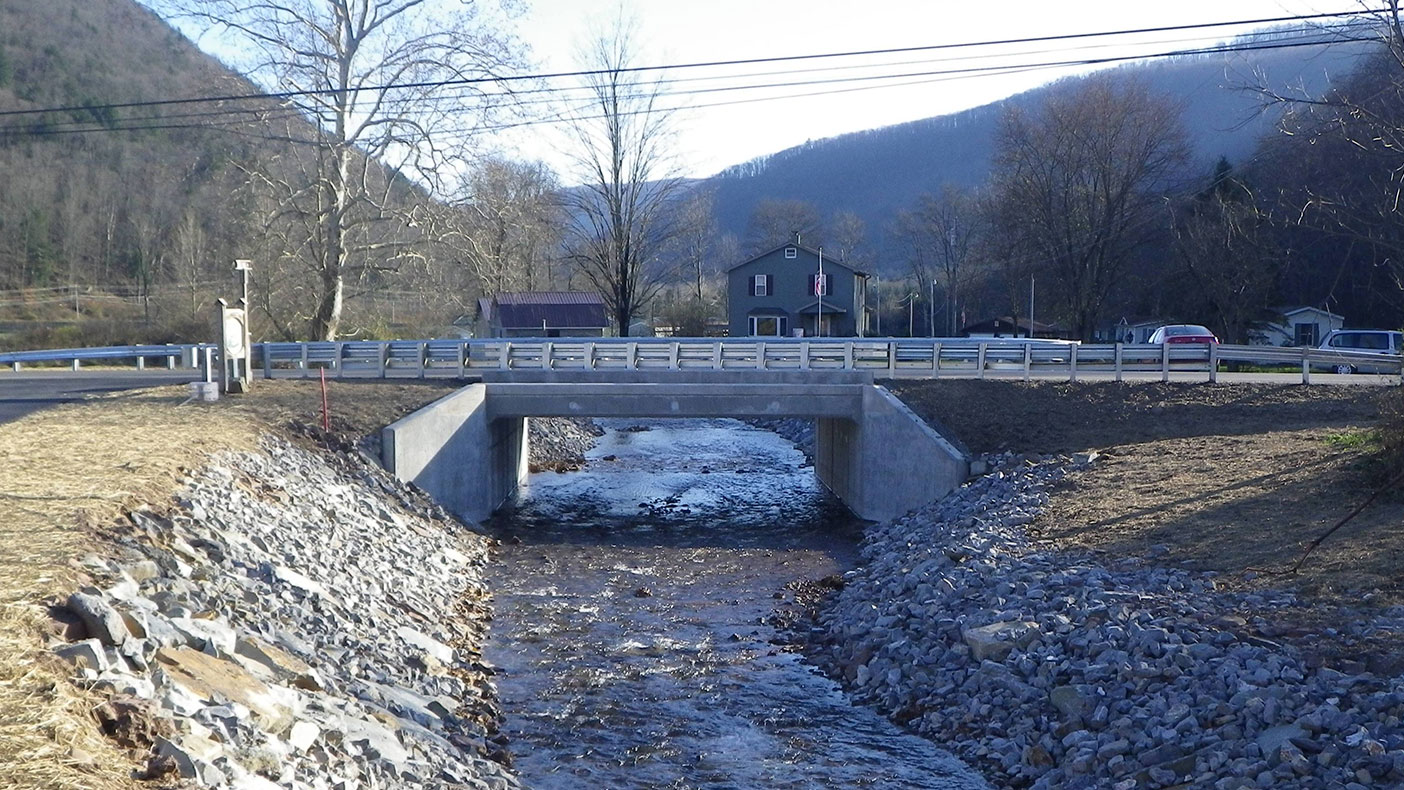 We designed the new bridge, which consists of a 26-foot by eight-foot single-cell precast reinforced concrete box culvert at grade with precast end sections. 