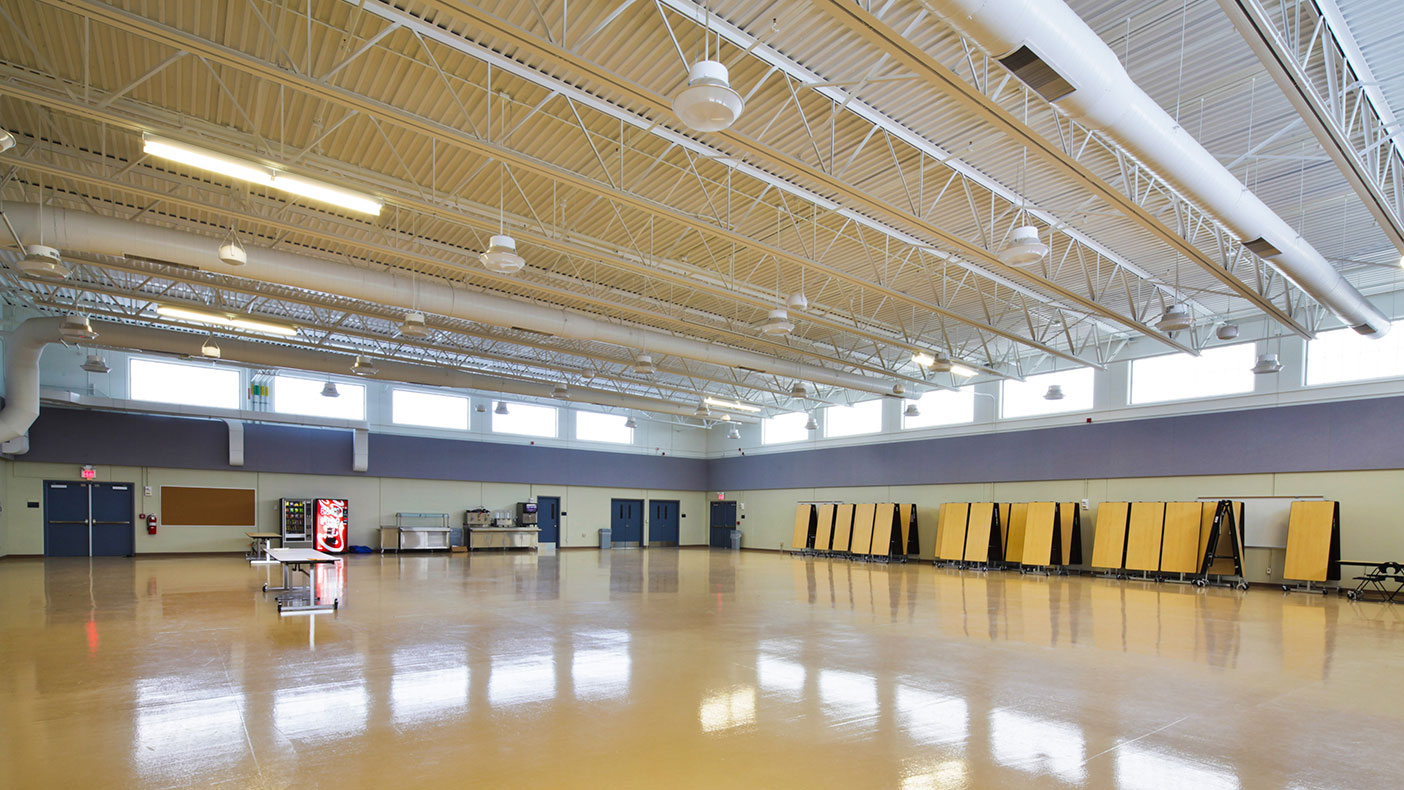 More than 8,000-SF of clear space for the assembly area serves multiple functions including indoor drills and dining.