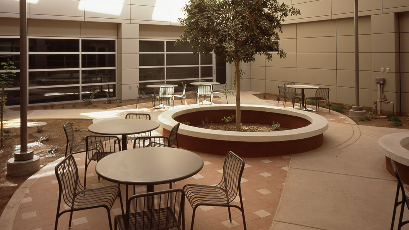 Long, narrow, horizontal windows along three facades combine with heavily screened clerestory windows and two interior courtyards to provide natural light while guarding against the intensity of the desert sun.