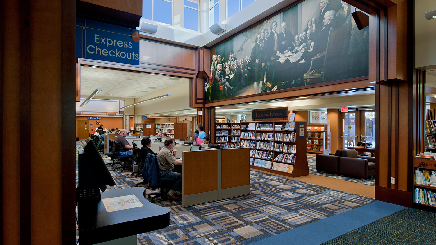 The library houses approximately 80,000 books and other materials on low merchandizing shelving, as well as 40 public computers, and a “Founding Fathers” collection.