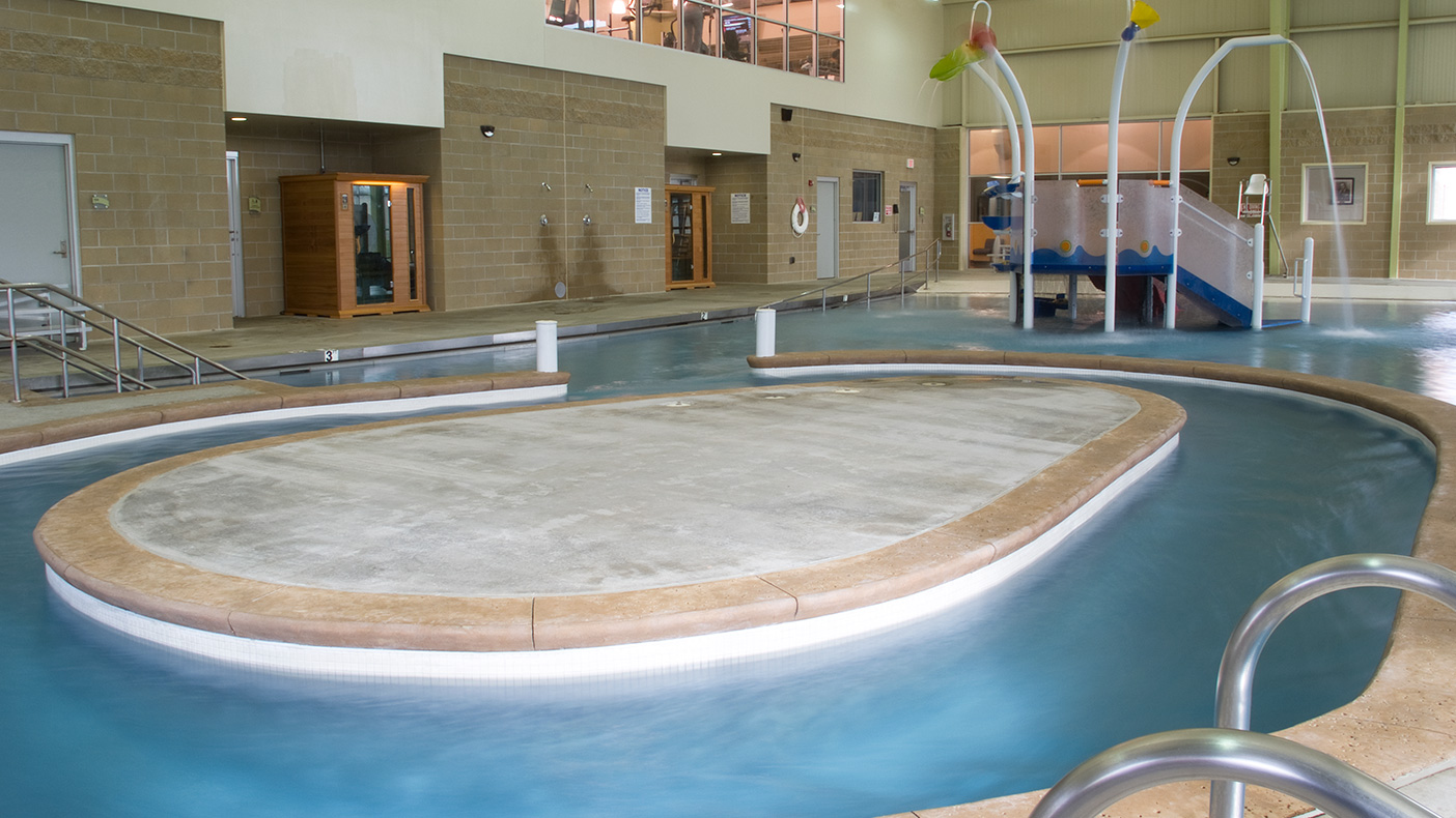 The Hutcherson Family YMCA features a family-oriented swimming pool with multiple play features.