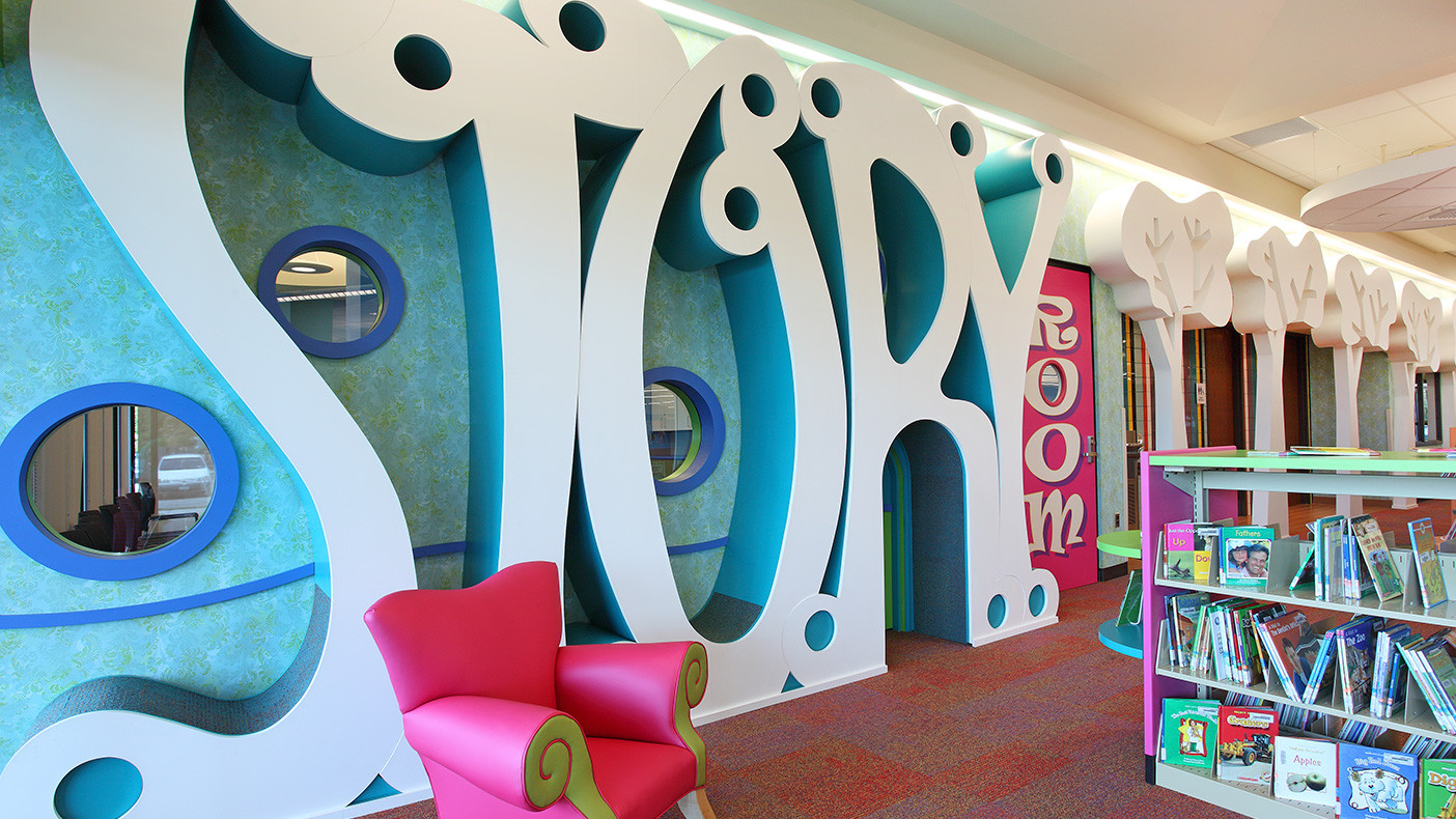 The children’s storytelling room can be identified by a row of “letter trees” that create carpeted reading nooks for all ages.