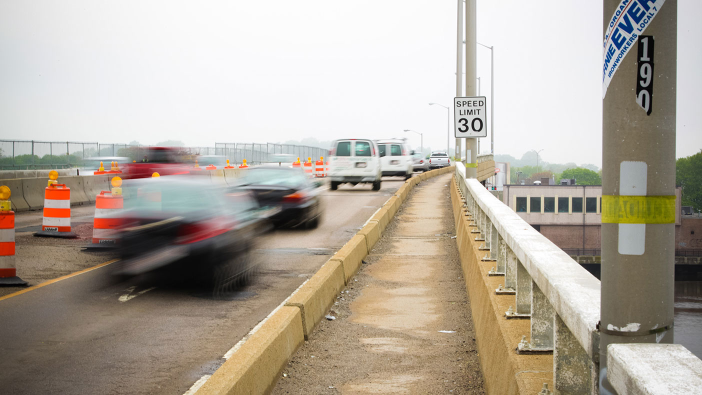 The pre-rehabilitation roadway conditions included poor pedestrian accessibility and a deteriorated, potholed roadway.