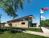 The southwest corner of the building features a two-story public lobby as well a transparent community room. The south public parking lot also includes access to the adjacent park’s walking and jogging paths.