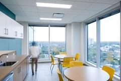 Floor-to-ceiling windows surround the walls of the single-floor office, seen here in the kitchen.
