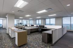 Low-partitioned cubicles are surrounded by glass-enclosed offices to facilitate daylighting.