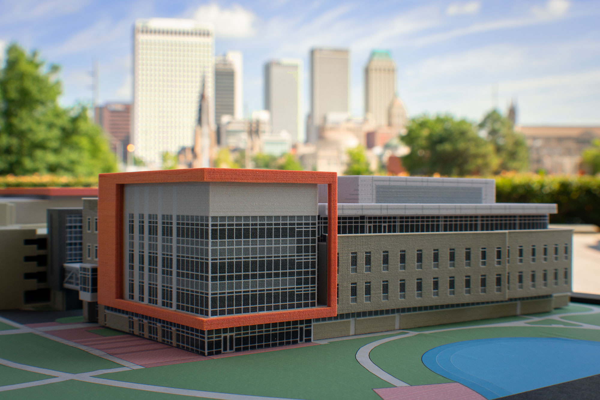 A model of the new building provides a 3D visualization.