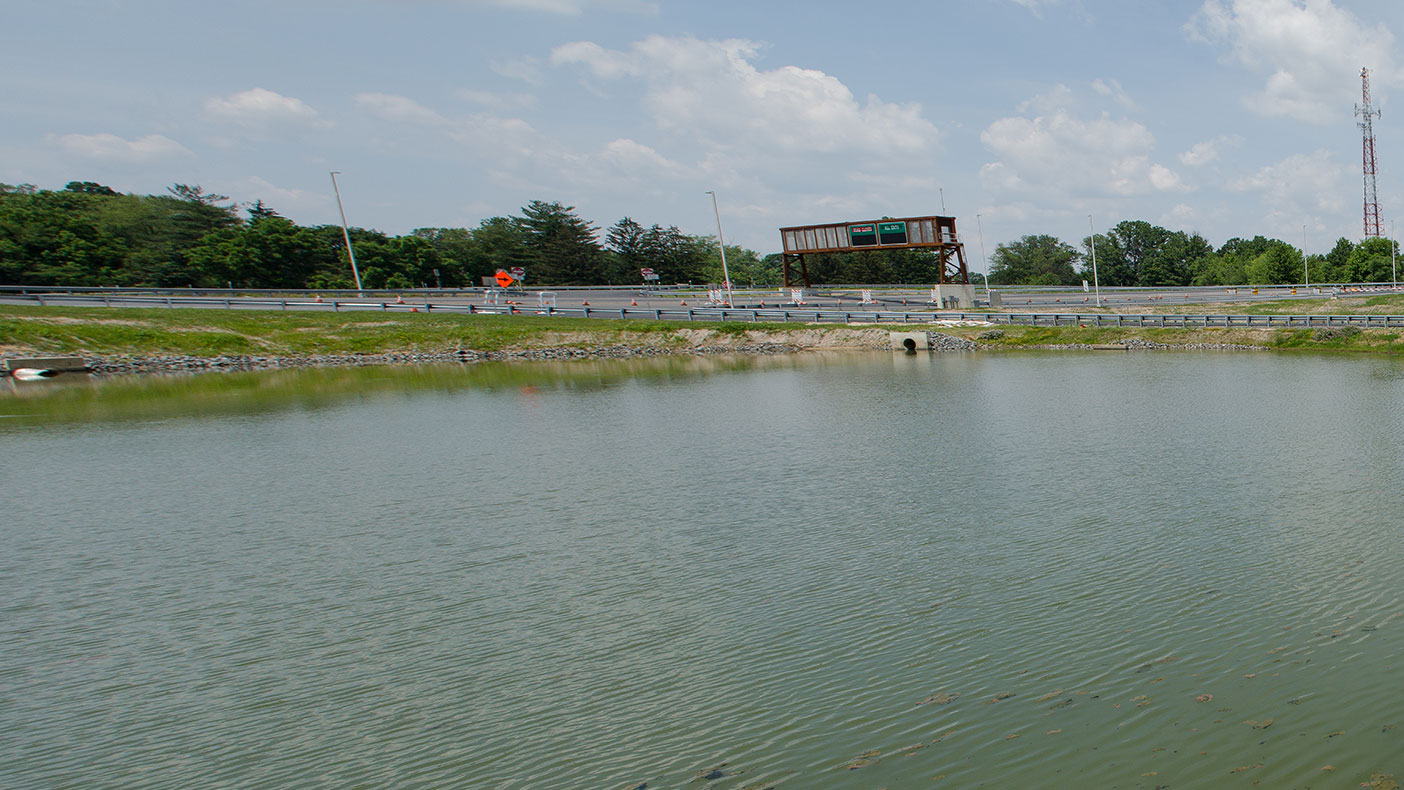 Sustainable technologies treated roadway surface runoff. Sediment forebays, sluice gates, and hinged trash racks reduced maintenance requirements, and we specified a clay liner to separate clean groundwater from runoff in nearby basins.