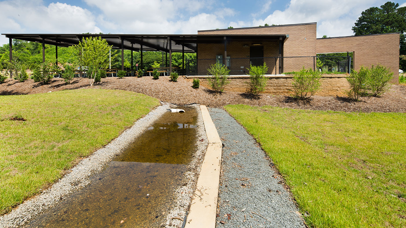 The level spreader sits slightly downhill from the gardens, and the pavilions are used for presentations, meetings, dining, and gatherings. 