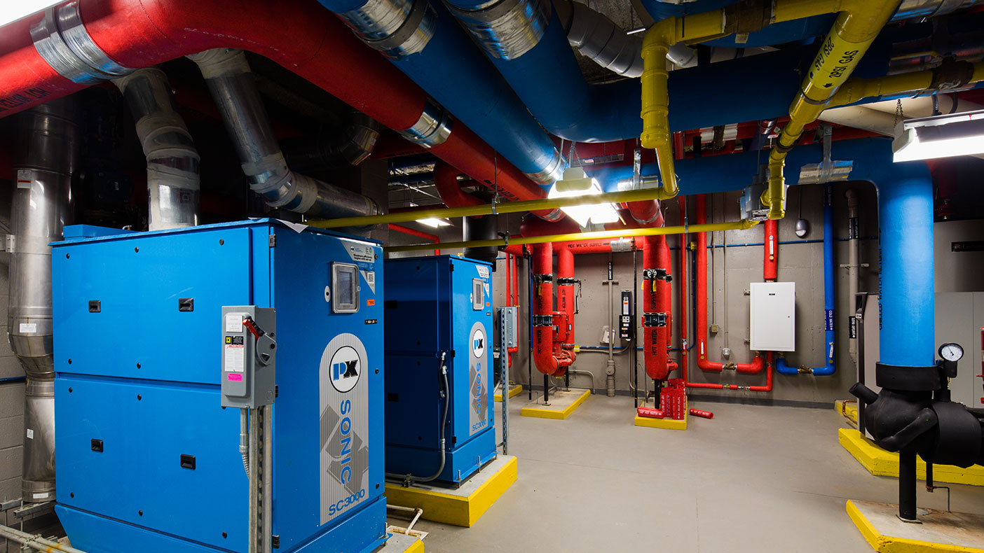 Two 100 percent outside air, water source heat pump units, one for each classroom wing, with heat recovery and hot gas reheat was provided to supply ventilation air to the classrooms.