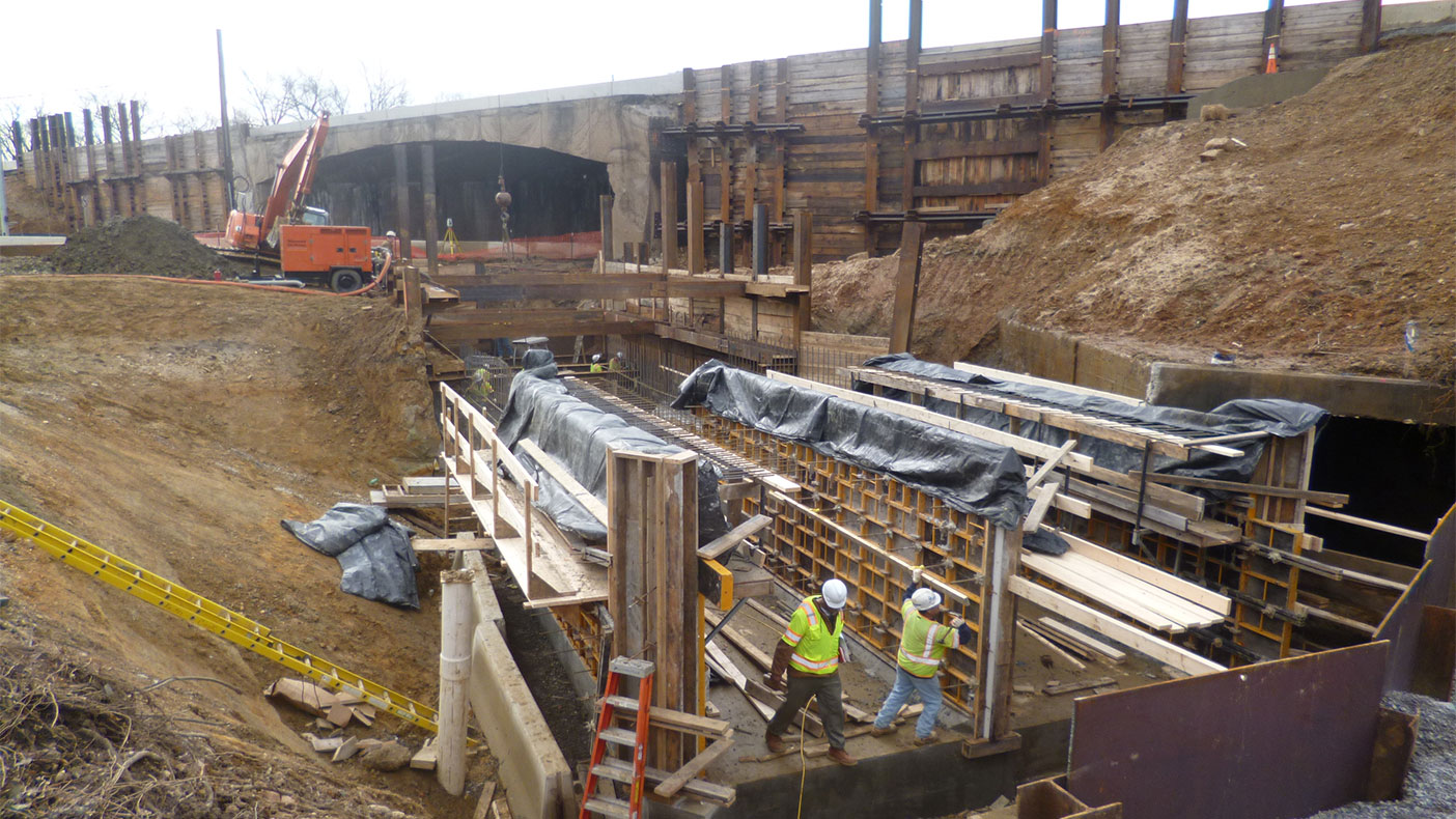 A cast-in-place dual-cell box culvert was constructed through the center of the interchange.