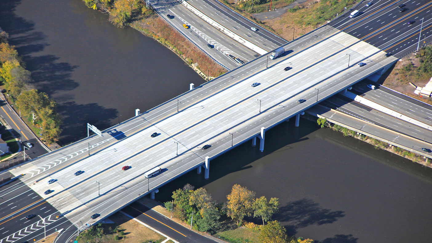 The finished bridge transports commuters and shipping trucks safely over the Passaic River.