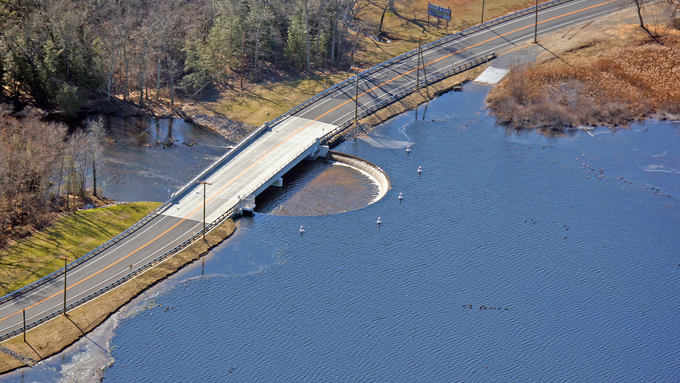 With the construction of the new 200-foot-long semi-circular spillway, 110-foot-long two-span bridge, and restored dam/roadway, we returned the beauty of Rainbow Lake to the community.