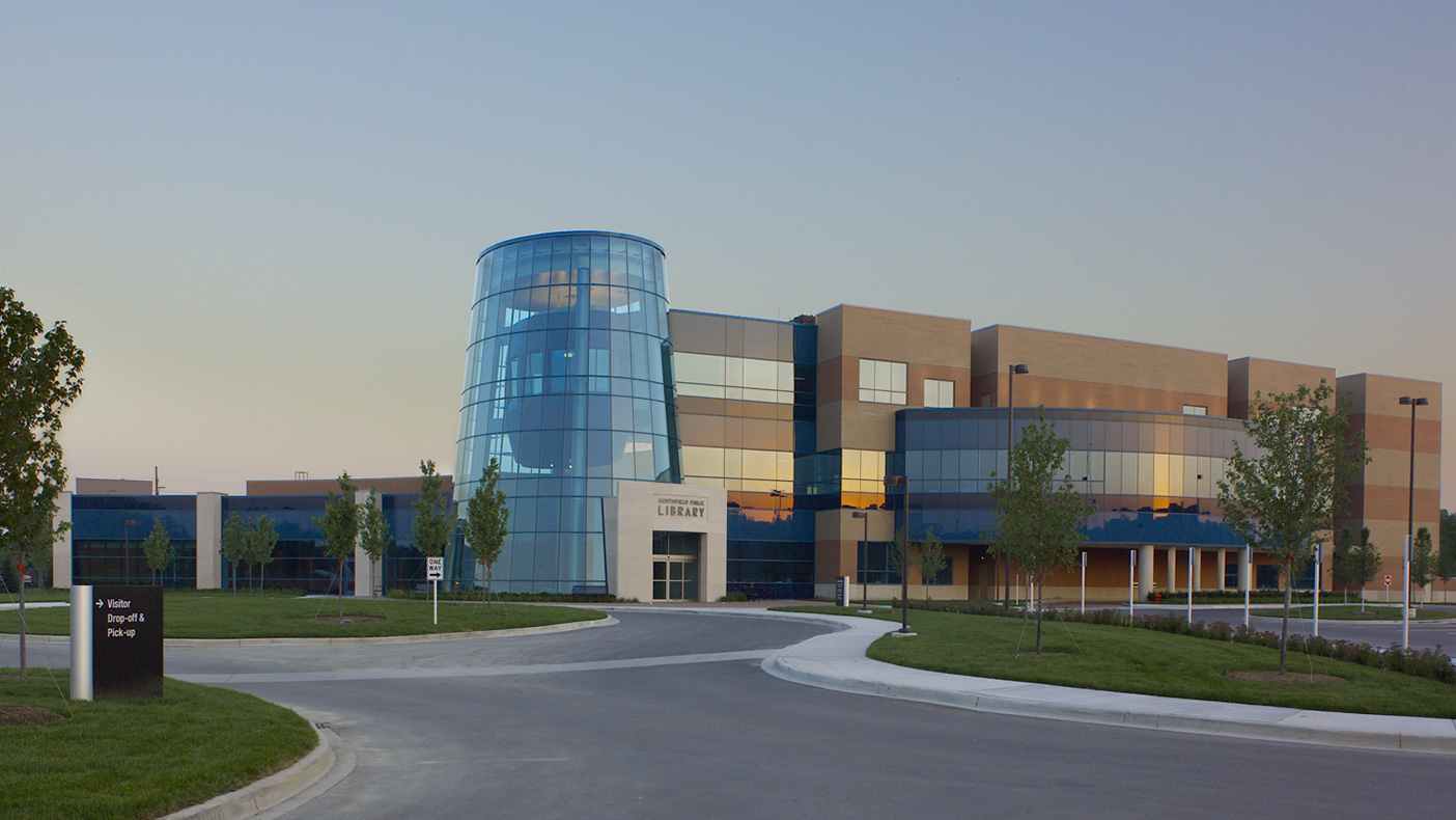 The grand entry features a three-story glass tower.