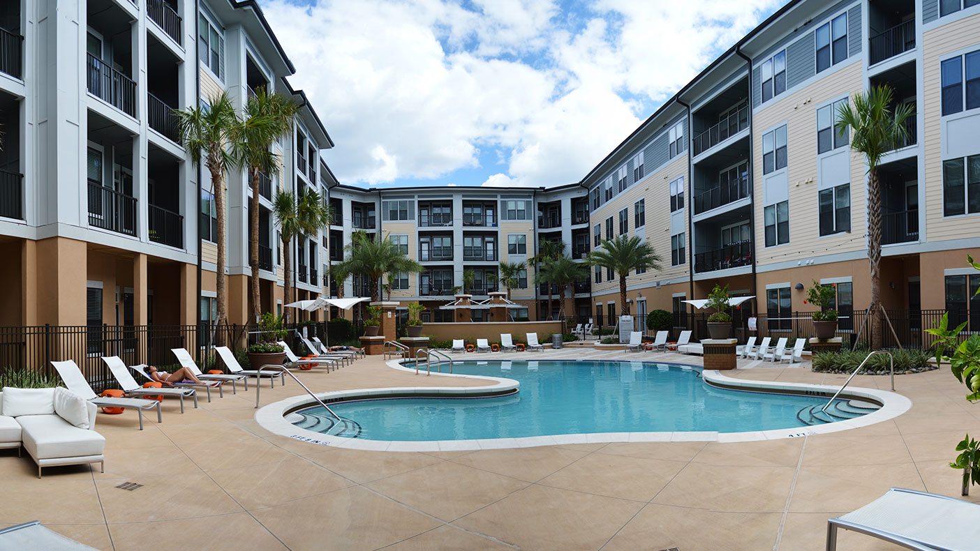 The project consists of 235 one-bedroom and 92 two-bedroom units built around central courtyards and a five-story parking structure.