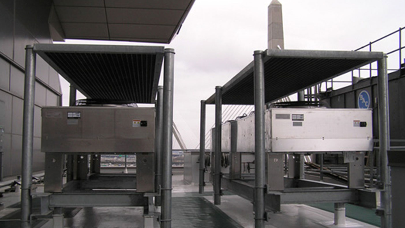 Two 30-ton split system A/C units were installed with the condensers located on custom steel frames on the roof of the building.