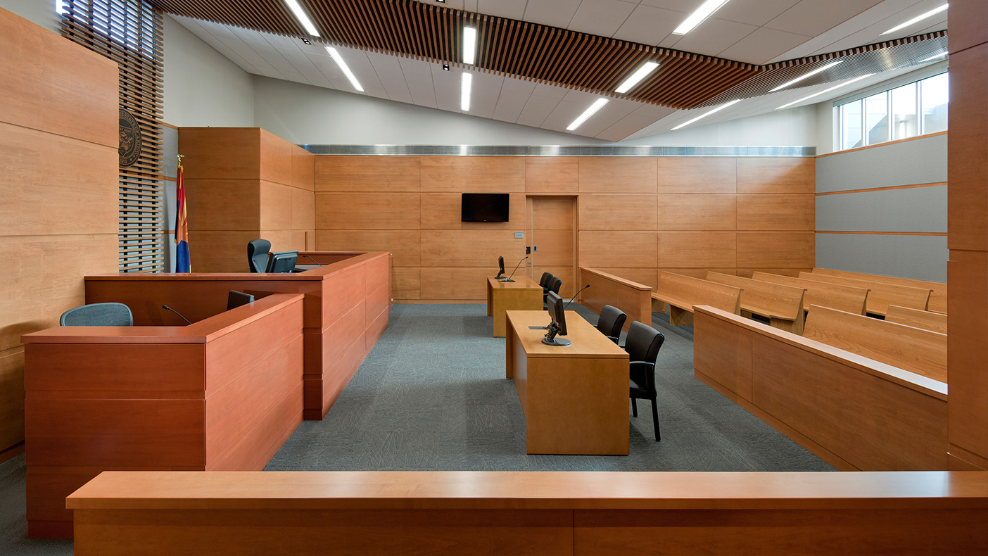 The municipal courtroom echoes the butterfly ceiling and also includes two-toned wood casework, an elevated judge's bench, jury box, court seating for 55, and custom city and state seals cast in metal.