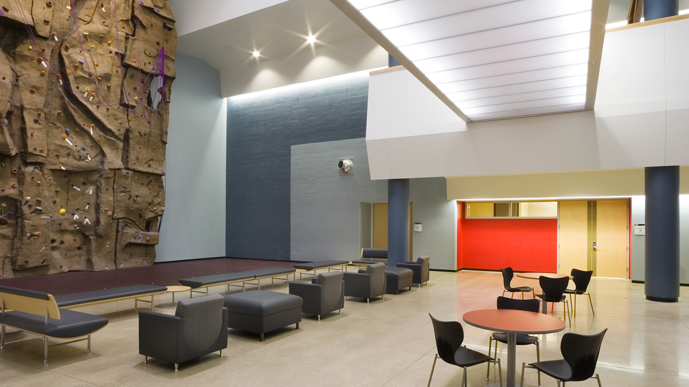 A “freeform” sculpted climbing wall rises 50 feet high within the atrium space.