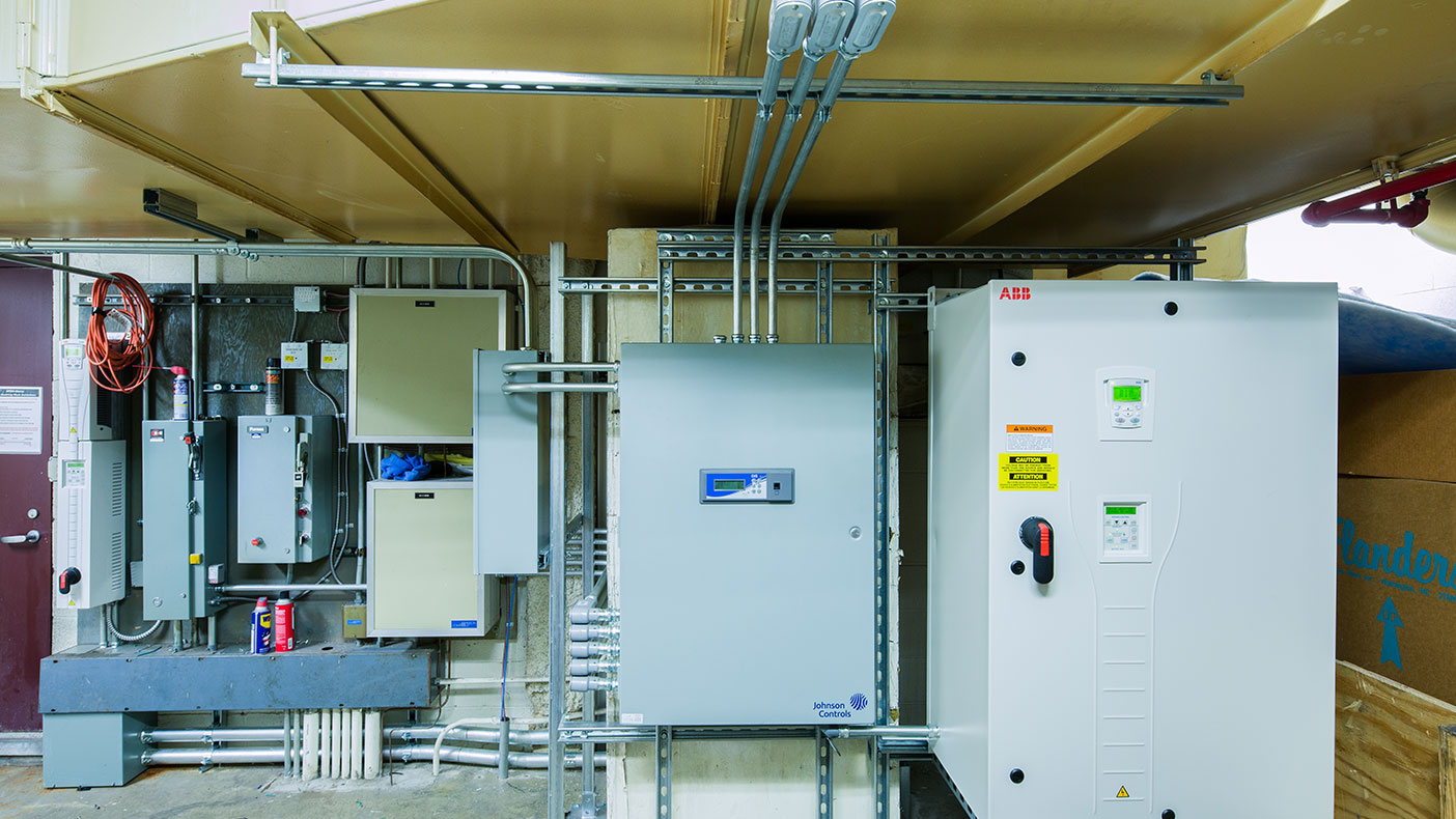 Variable frequency drives and new premium efficiency motors were installed where existing vane air flow control methods were found functionally incorrect.