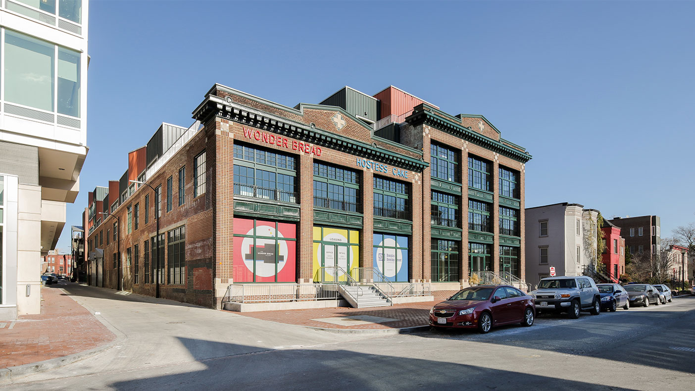 As part of the transformation, the front of the building was excavated to allow for natural light to flow through the large glass windows throughout the building.