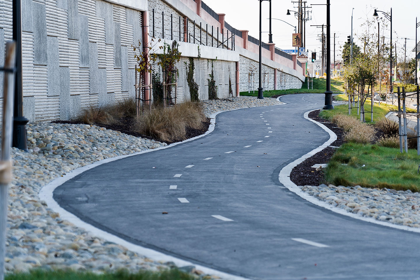 This view shows the adjacent bike path and landscape elements.