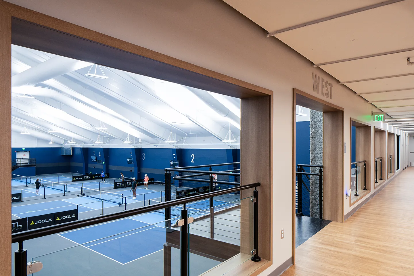 Via the overlooks, guests can observe pickleball matches from the dining and seating areas.