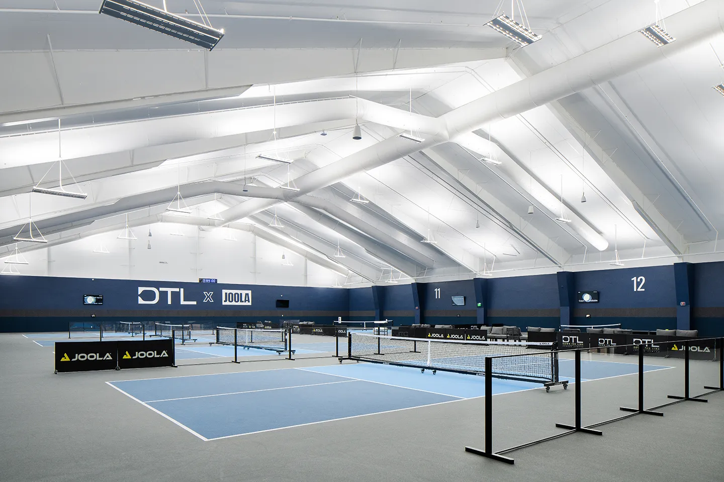 The renovated facility includes 12 champion-sized pickleball courts with a clean, modern design.