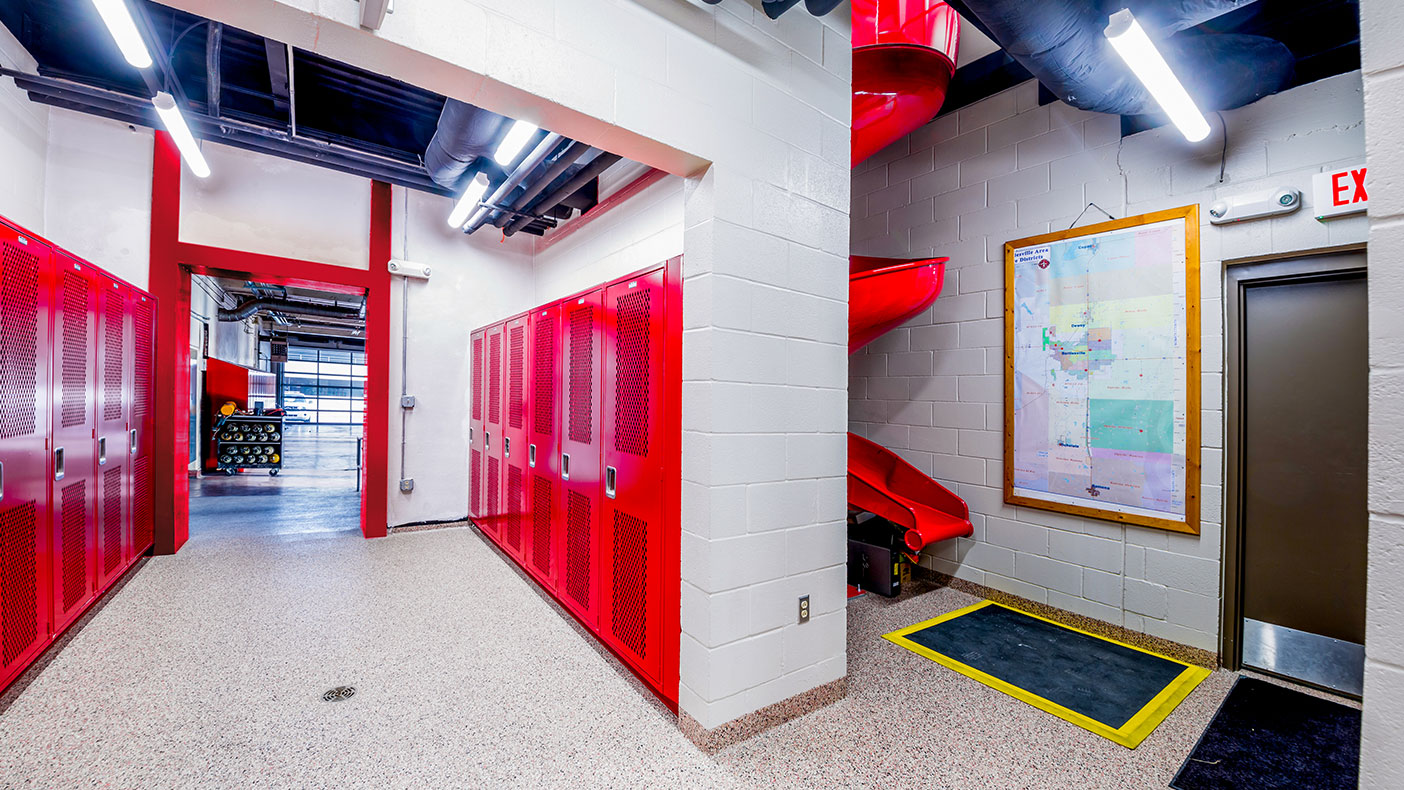 The fire station’s addition features a 90-foot drive thru apparatus bay with a new elevator, slide, and stairs.
