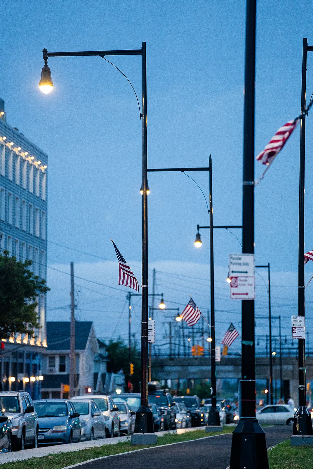 Beach 108th Street’s new bike lanes and parking illuminated by the streetlamps.