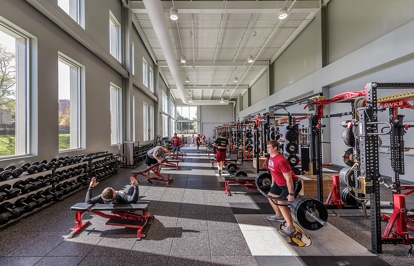 Natural light and volume energize the athletic weight room.