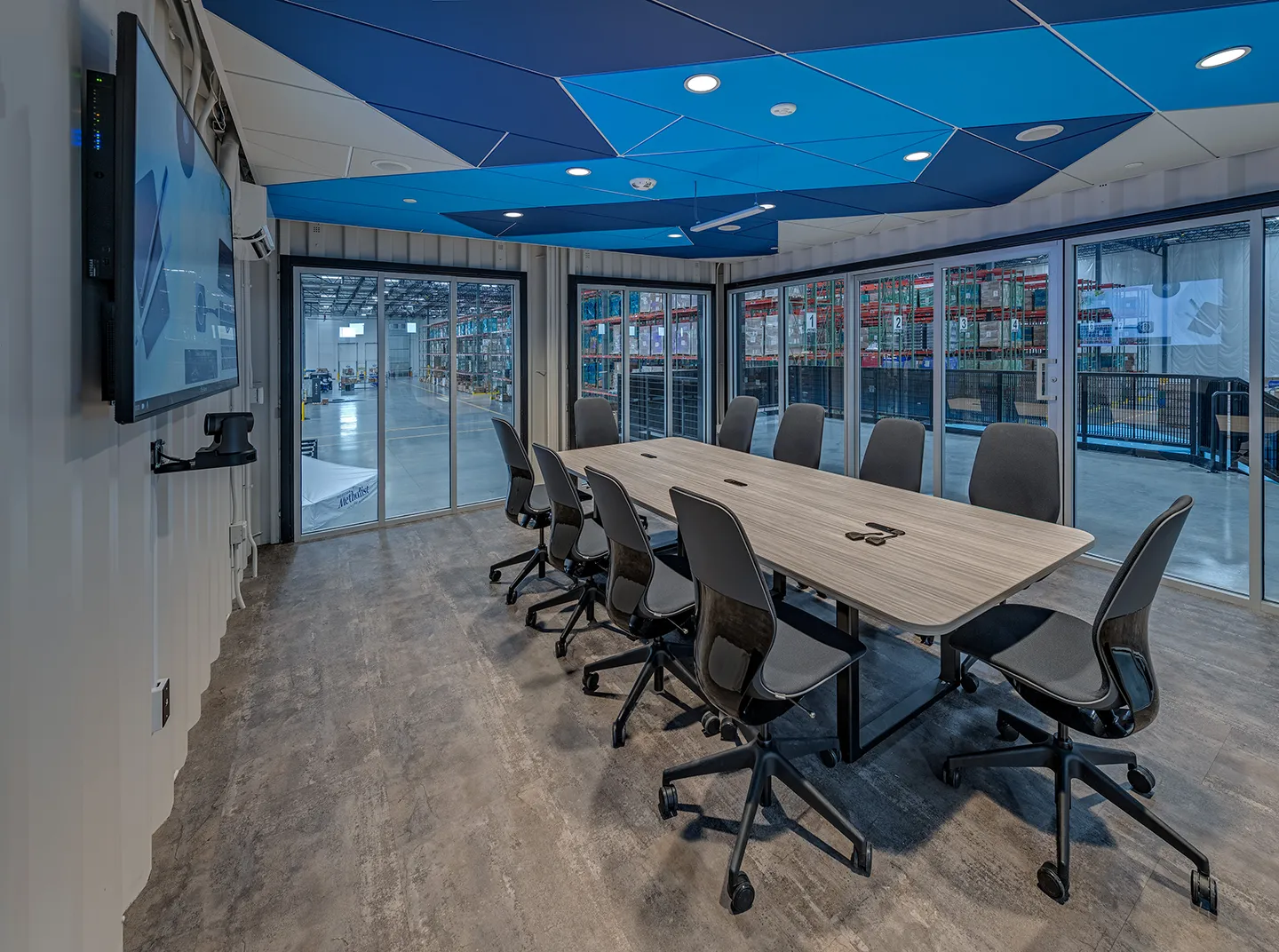 A small teaming room offers a quiet, comfortable atmosphere inside this modified shipping container on the warehouse floor.