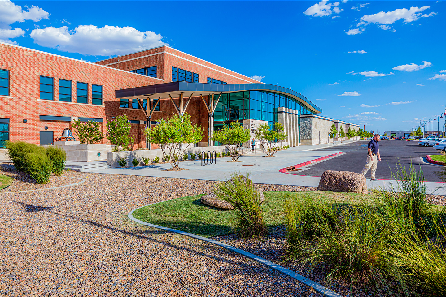 The civic stone base and contemporary cornice tie together the primary design elements of traditional brick, civic stone, and public transparency of the four program and three building structures.