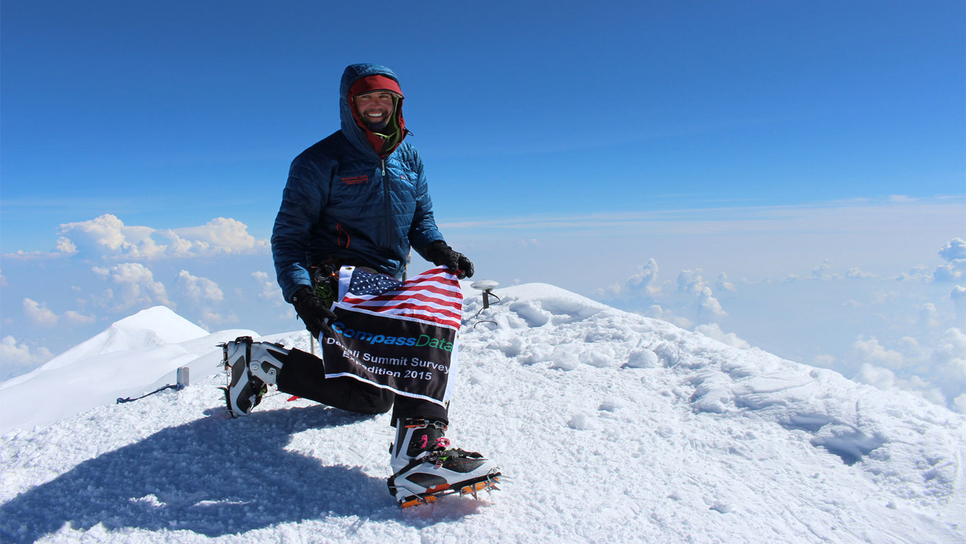 Blaine Horner, survey party chief with CompassData at the summit on June 24, 2015, places a GPS antennae at the summit of Denali for future data collection.