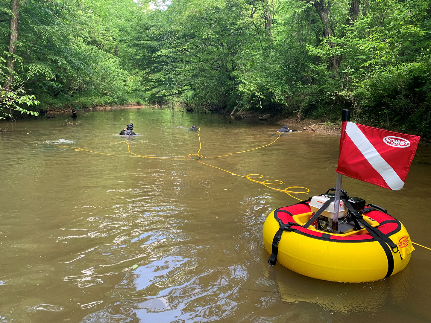 Biologists search the bottom of deep rivers and lakes for mussels using a surface supplied air system that allows them to stay under water without using cumbersome SCUBA equipment.