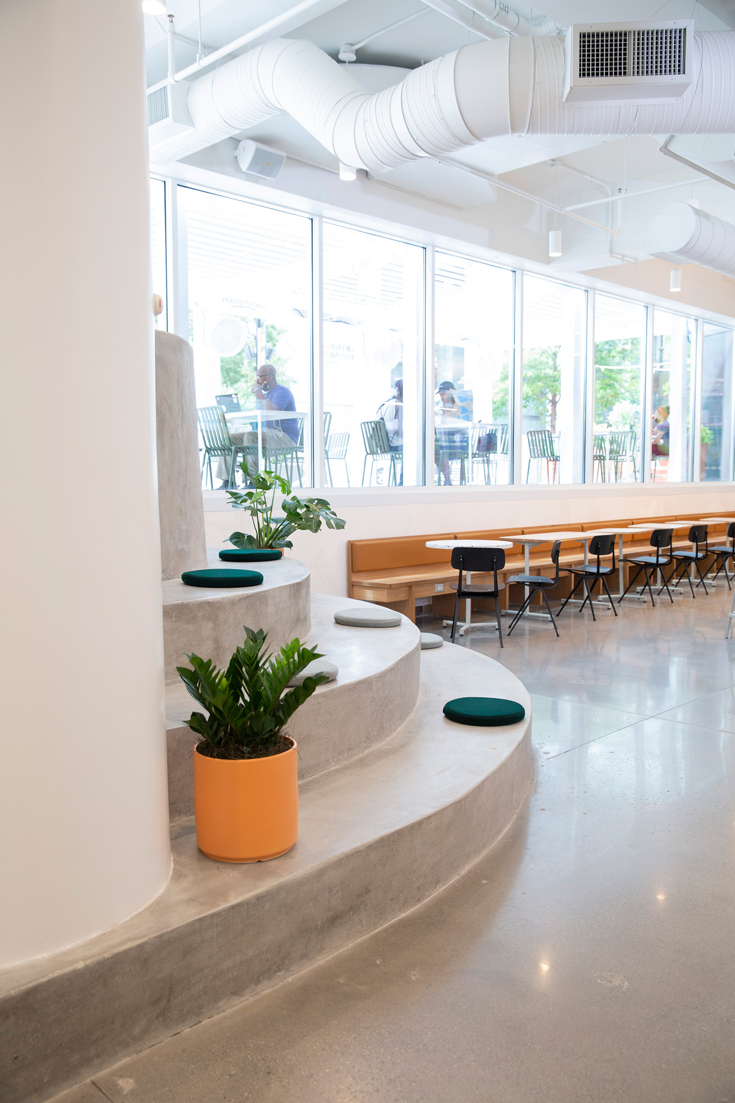 Leveraging the interior grade change, this Atlanta location created a youthful concrete stadium stair and seating area.