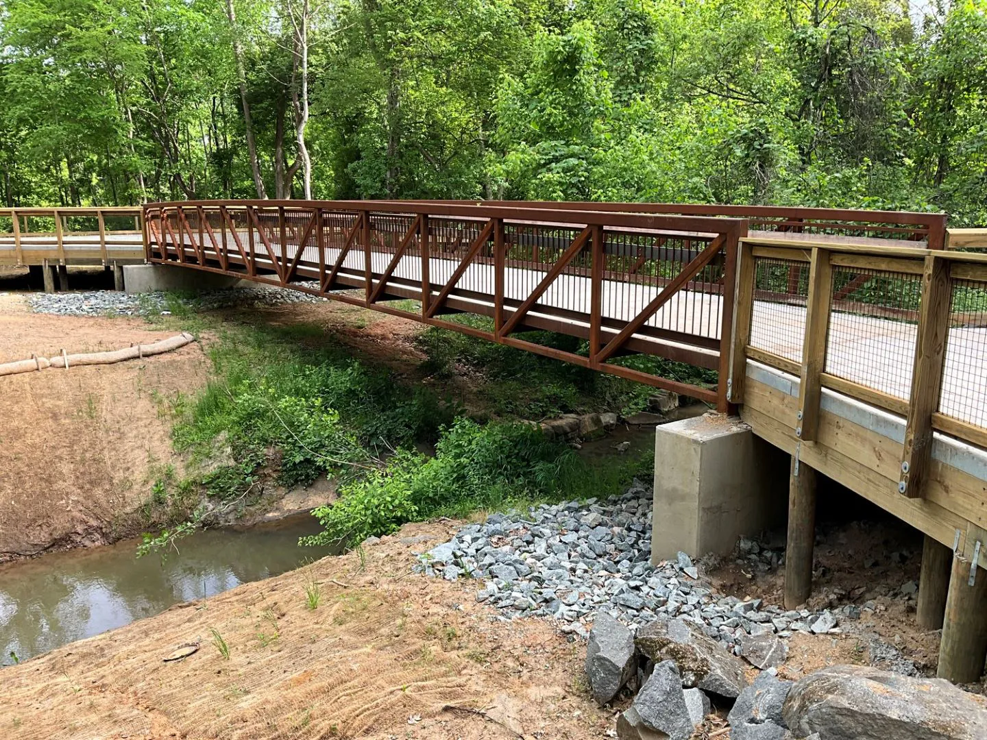 The greenway traverses unique terrain within a floodplain and floodway with multiple wetlands, along with significant rock outcrops not commonly found in the piedmont.