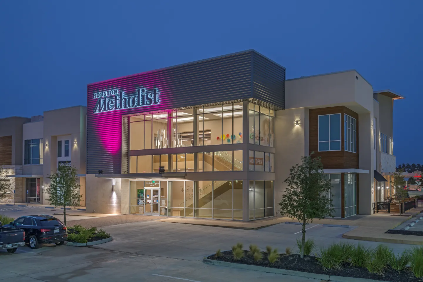 The illuminated two-story interior draws patients, visitors, and staff in and up to the main lobby.